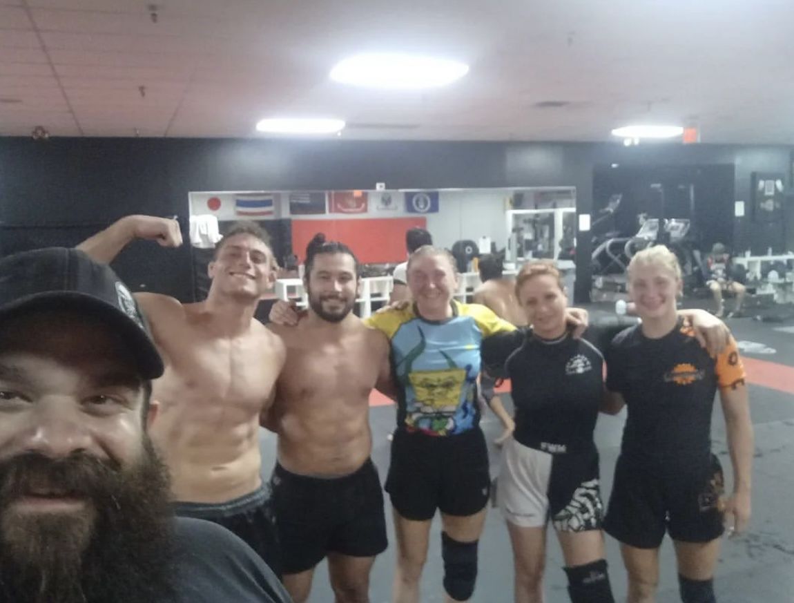 Jay Regalbuto coaching Keren from the corner during a grappling match